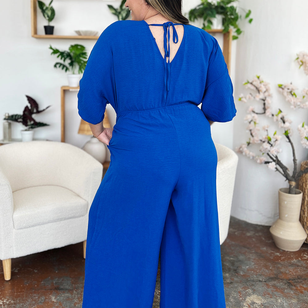 
                      
                        Double Take Full Size Surplice Wide Leg Jumpsuit with Pockets
                      
                    